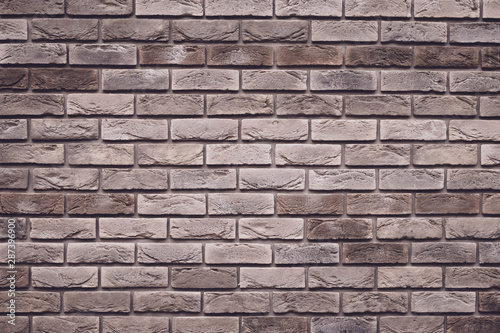 Brown brick wall background. Grunge texture. Vintage rough brickwork. Decorative tile surface. Bricks backgrounds. Messy wall pattern for wallpaper design.