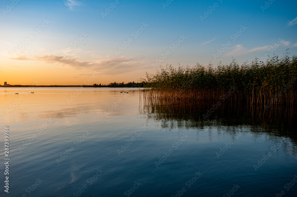 view of a beautiful lake at sunset