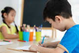 asian children drawing on the table in classroom back to school concept