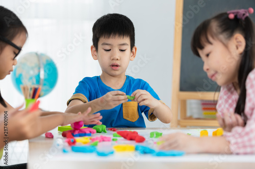 children playing clay coloured on the table back to school concept