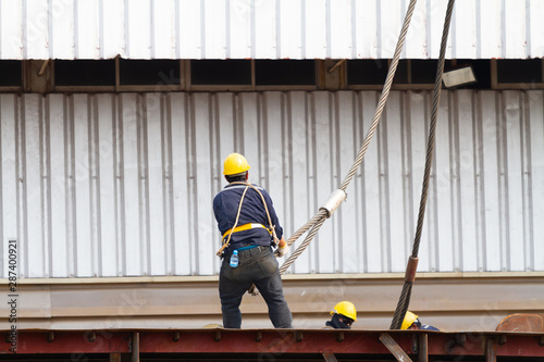 Worker pulling heavy duty steel wire