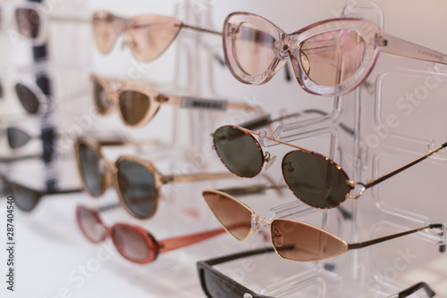 rack with stylish trendy plastic glasses. Retail sale of stylish glasses