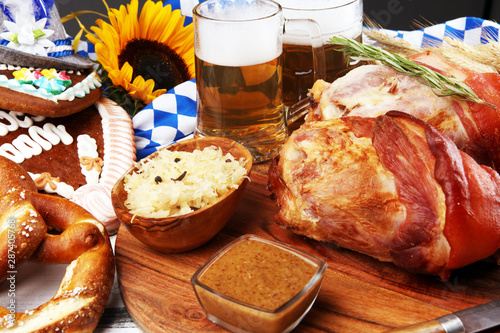 Traditional German cuisine, Schweinshaxe roasted ham hock. Beer, pretzels and various Bavarian specialties. Oktoberfest background