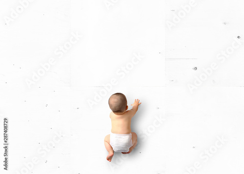 Cute baby crawling on the floor top view