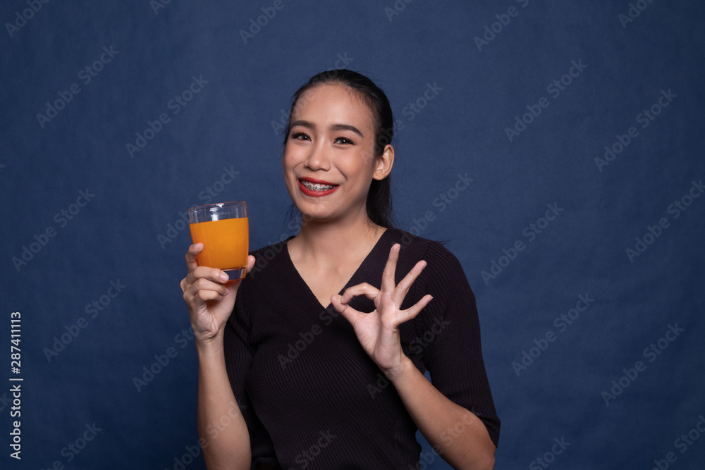 Young Asian woman show OK drink orange juice. Young Asian woman show OK drink orange juice.