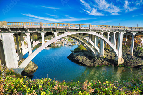 U.S. 101 highway over the entrance to Depoe Bay, Oregon, touted as the world's smallest natural navigable harbor. Its narrow, 50 foot wide channel (below bridge) leads directly to the Pacific Ocean. © Phil Lowe
