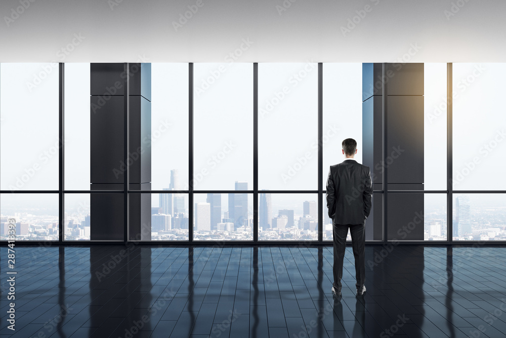 Fototapeta premium Businessman in bright office interior