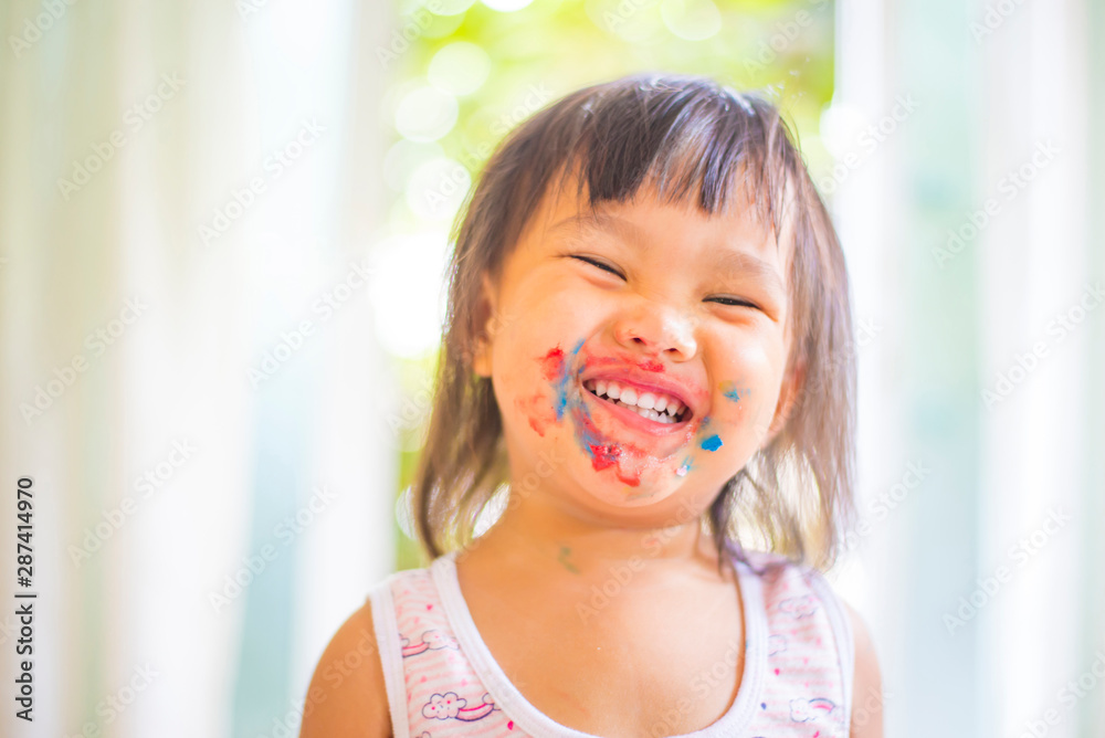 A photograph of the face of a happy smiling Asian girl. A photograph of the face of a happy smiling Asian girl.