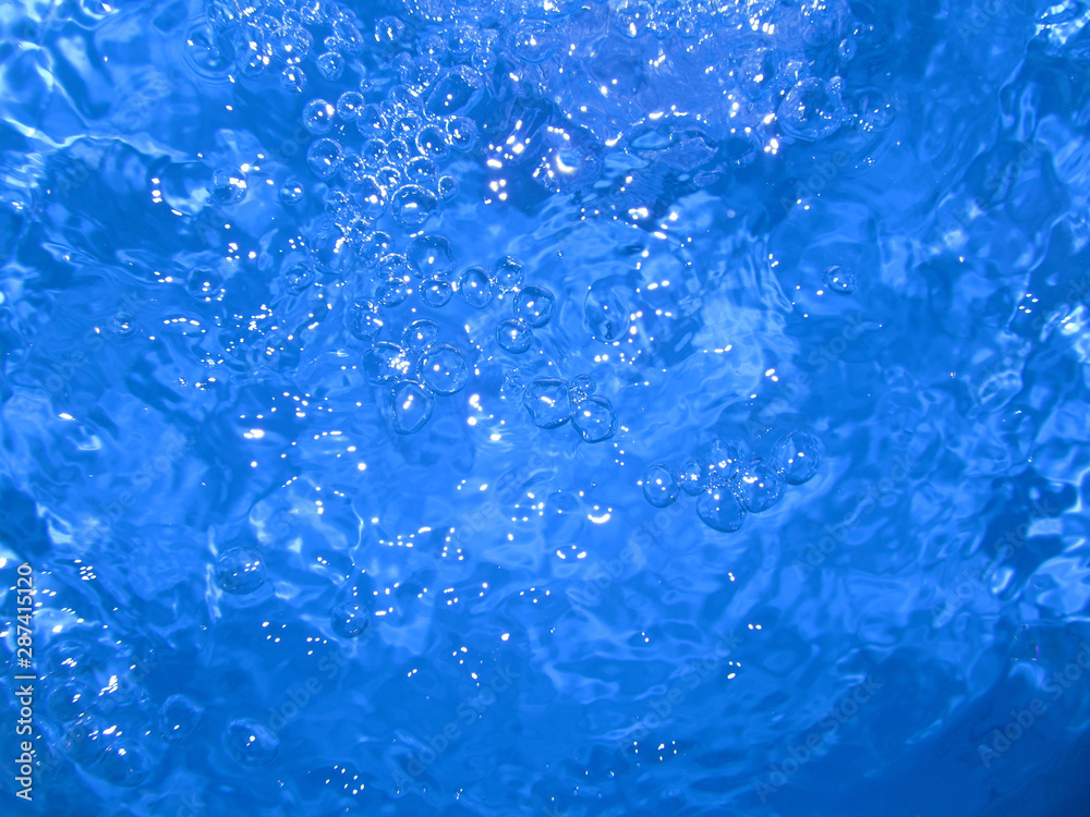 Bubbles in water. Water surface after splash. Reflection of light on the water. Bubbles in water. Water surface after splash. Reflection of light on the water.