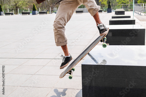 Closeup of skateboarder legs doing trick on stairs
