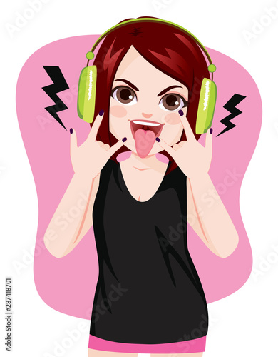 Young rock girl making horns hand gesture showing tongue while listening to music with headphones