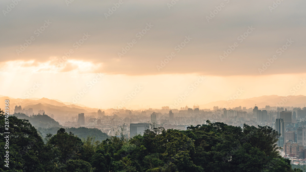 Layers of Panorama Taipei cityscape and mountains with sunlight when the sun going down that view from Xiangshan Elephant Mountain in the evening in Taipei, Taiwan.