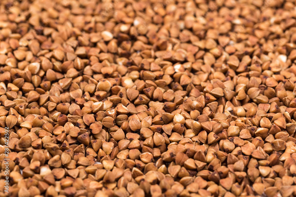 Macro Photo food buckwheat groats. Texture background grain buckwheat groats. Image food product porridge buckwheat grains Macro Photo food buckwheat groats. Texture background grain buckwheat groats. Image food product porridge buckwheat grains