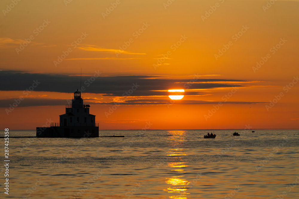 sunrise over lake and mouth of Manitowoc river Lighthouse at Manitowoc Harbor on Lake Michigan in Wisconsin