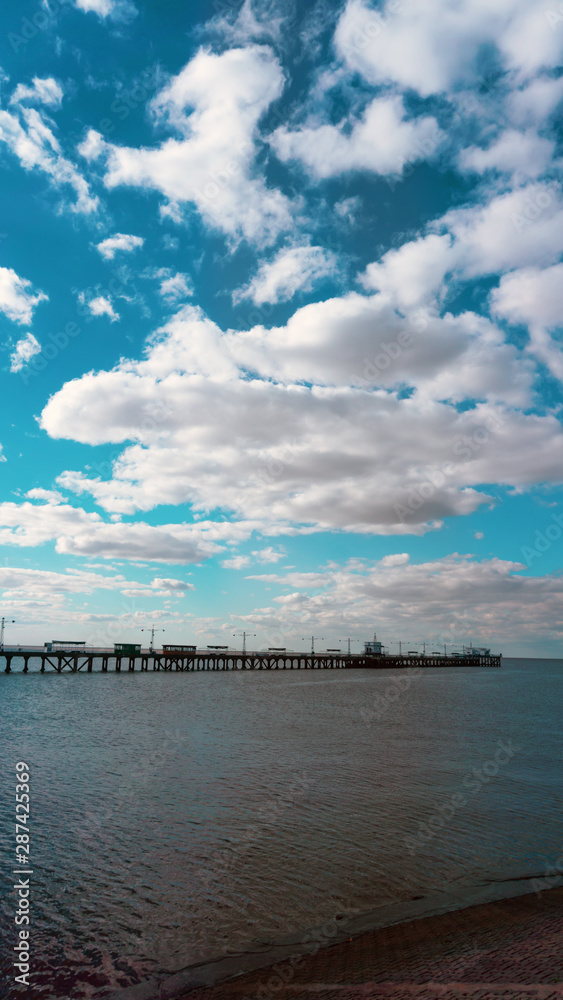 Pier with partly cloudy sky in the afternoon