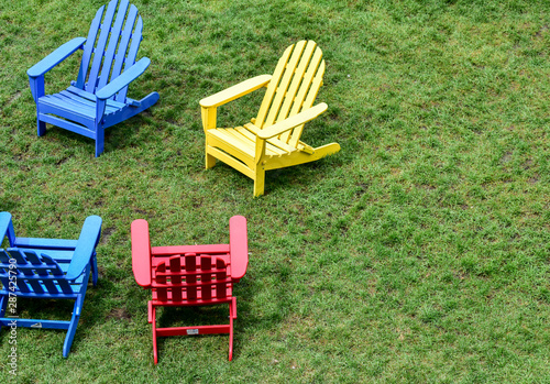 empty lawn chairs on the grass in the city park