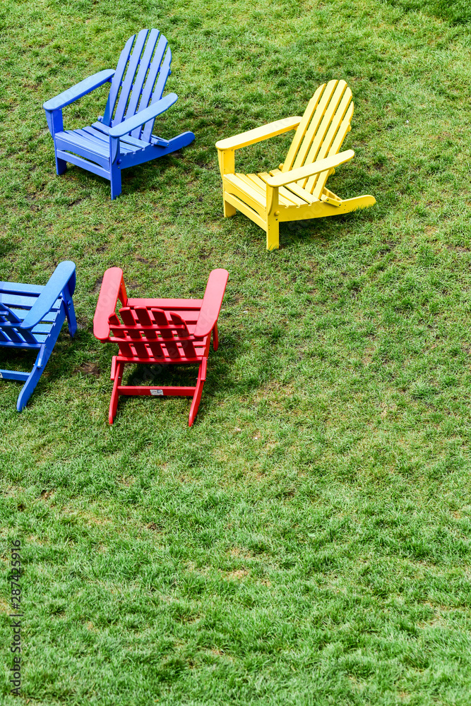 empty lawn chairs on the grass in the city park empty lawn chairs on the grass in the city park