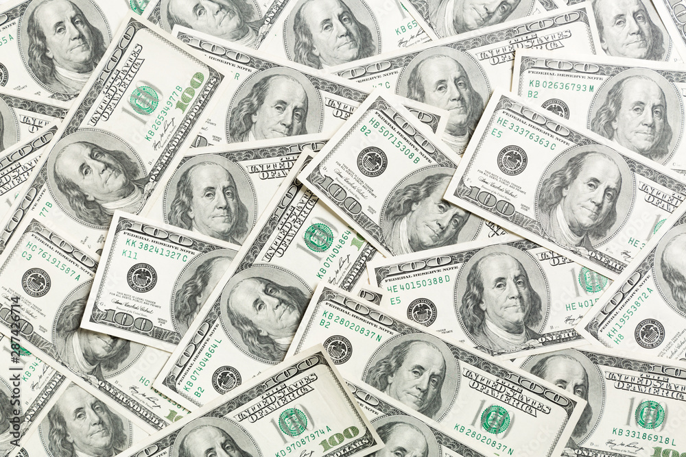 Top view of one hundred dollar banknotes made as a background. USD currency concept. Texture of American dollars Top view of one hundred dollar banknotes made as a background. USD currency concept. Texture of American dollars