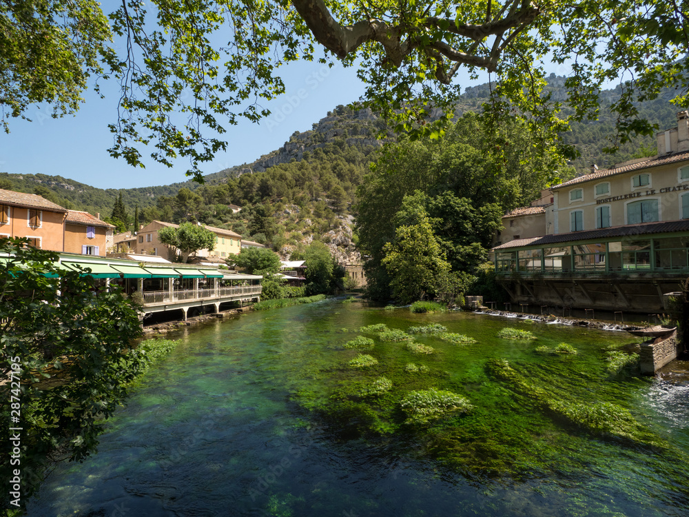 Fototapeta premium France, july 2019: Fontaine-de-Vaucluse, a small typical town in Provence. Beautiful village, with view on roof and landscape, small cafe and restaurants.