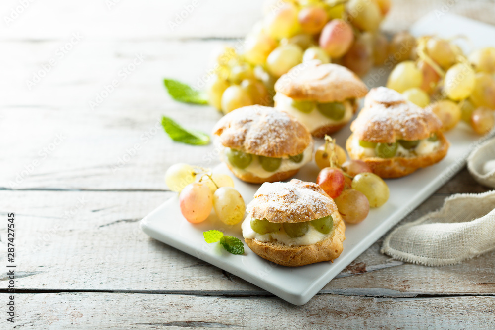Profiteroles with custard and grape