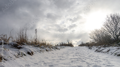 Fotografie Cold Winter white landscape with snow in the fields and clouds
