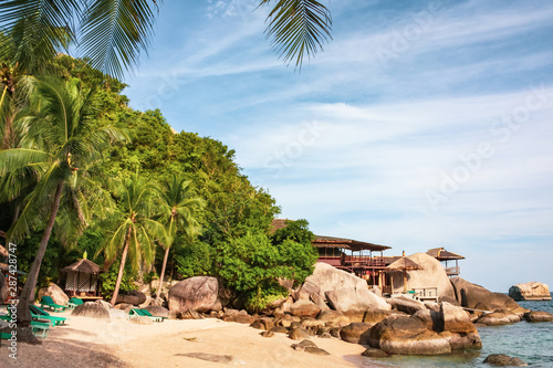  The beautiful paradise beach of Koh Tao with large stones and coconut trees. Tropical view of Thailand