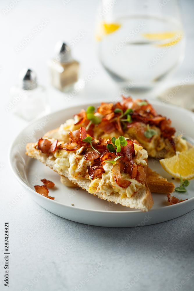 Scrambled eggs with bacon on toast Scrambled eggs with bacon on toast