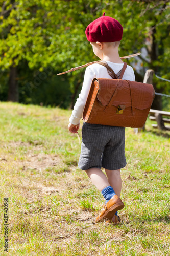 Принти на полотні Rural Way to School / Cute little elementary schoolboy seen from back walk outdo