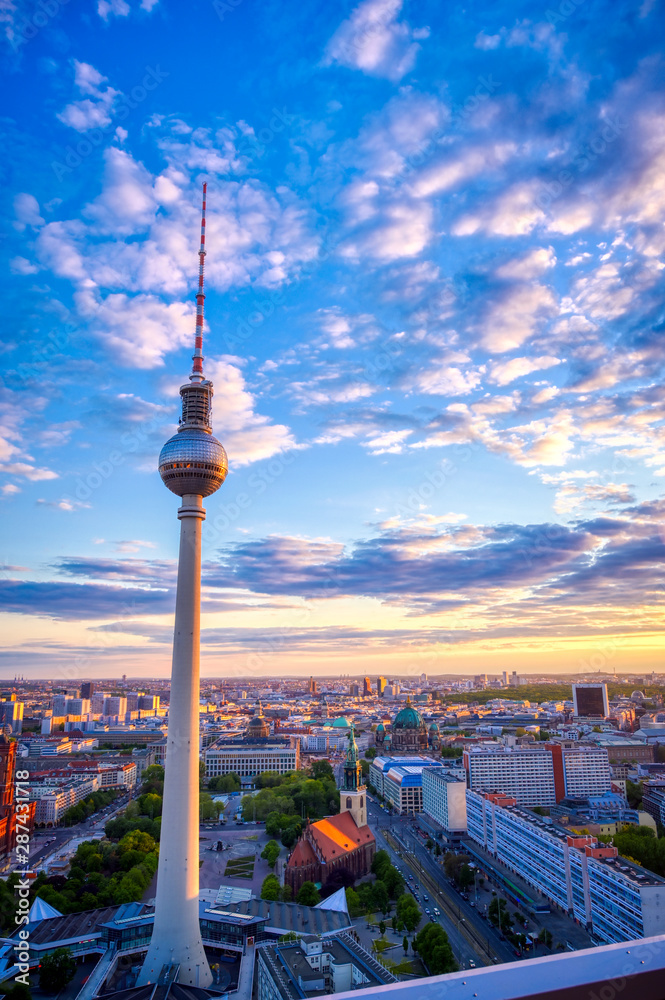 Fototapeta premium A view of the television tower (Fernsehturm) over the city of Berlin, Germany at sunset.