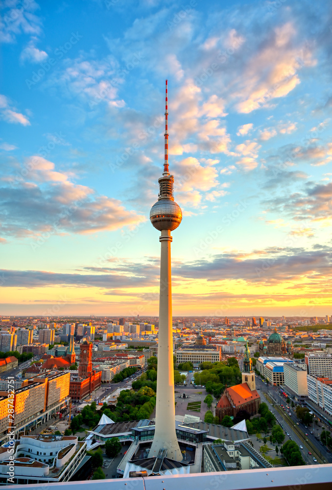 Naklejka premium A view of the television tower (Fernsehturm) over the city of Berlin, Germany at sunset.