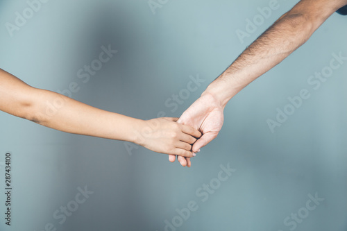 lovely man and woman hands on gray background