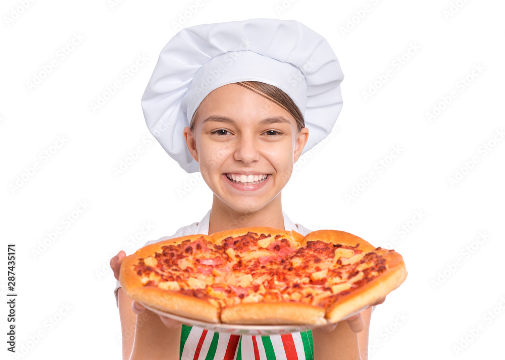 Happy beautiful teen girl in chef hat holding cooked pizza. Girl cook in apron holds plate with fresh pizza, isolated on white background. Portrait of cute child showing delicious Italian pizza. Happy beautiful teen girl in chef hat holding cooked pizza. Girl cook in apron holds plate with fresh pizza, isolated on white background. Portrait of cute child showing delicious Italian pizza.