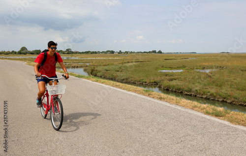 young boy with red bike