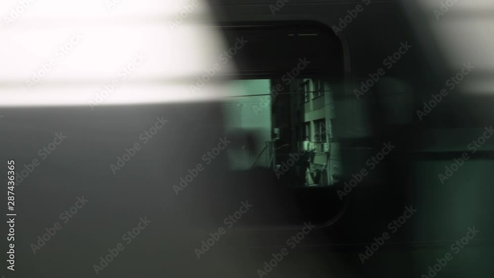 Urban trains passing each other, fast flashing view through the windows