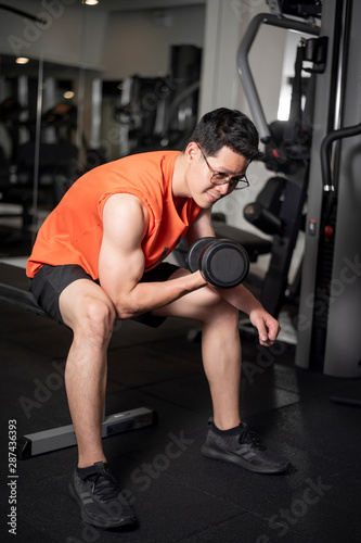 Asian man is working out  in fitness gym © tonefotografia