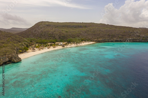 Aerial view of coast of Curaçao in the Caribbean Sea with turquoise water, cliff, beach and beautiful coral reef around Playa Largu