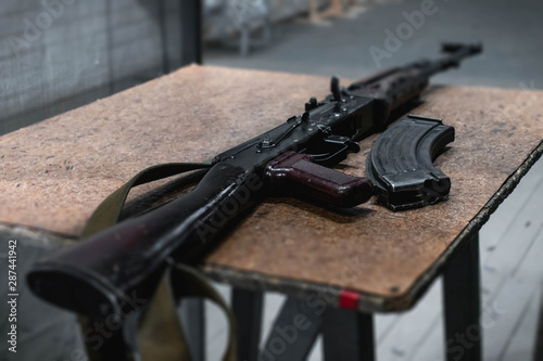 AK-47, gun and bullets on a table