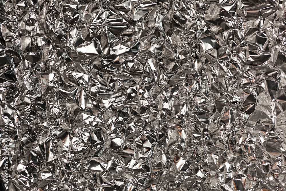 Full frame take of a sheeT of crumpled silver aluminum foil Full frame take of a sheeT of crumpled silver aluminum foil