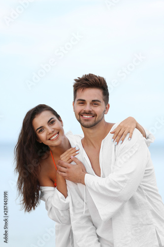 Happy young couple spending time together on beach