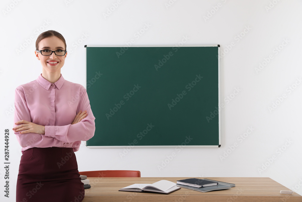 Portrait of young female teacher in classroom Portrait of young female teacher in classroom