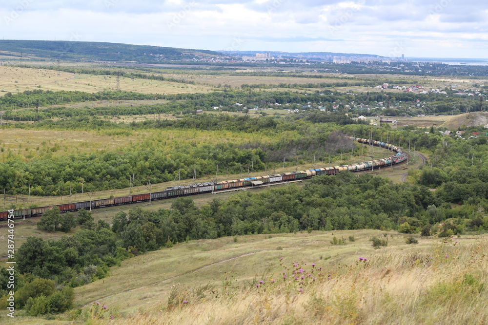 two long freight trains pass each other. Aerial photo
