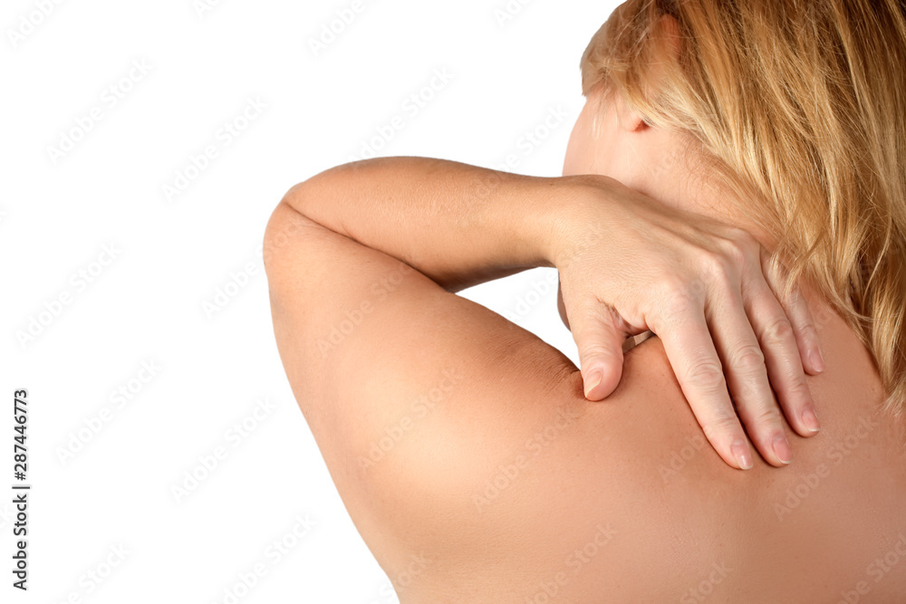 The woman suffers from pain and spasm in the neck and shoulder joint while holding her hand on the sore area of the body. The concept of women's health. The woman suffers from pain and spasm in the neck and shoulder joint while holding her hand on the sore area of the body. The concept of women's health.