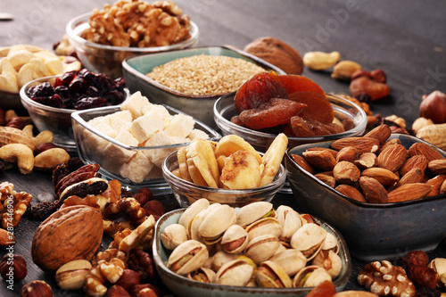 Composition with dried fruits and assorted healthy nuts on rustic background