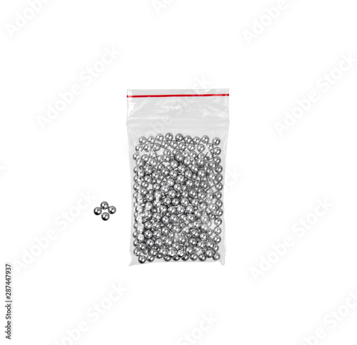 Steel balls in a plastic bag isolate on a white background. Balls for airguns. photo