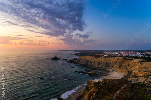 Aerial view of the Zambujeira do Mar village and beach at sunset  in Alentejo  Portugal 