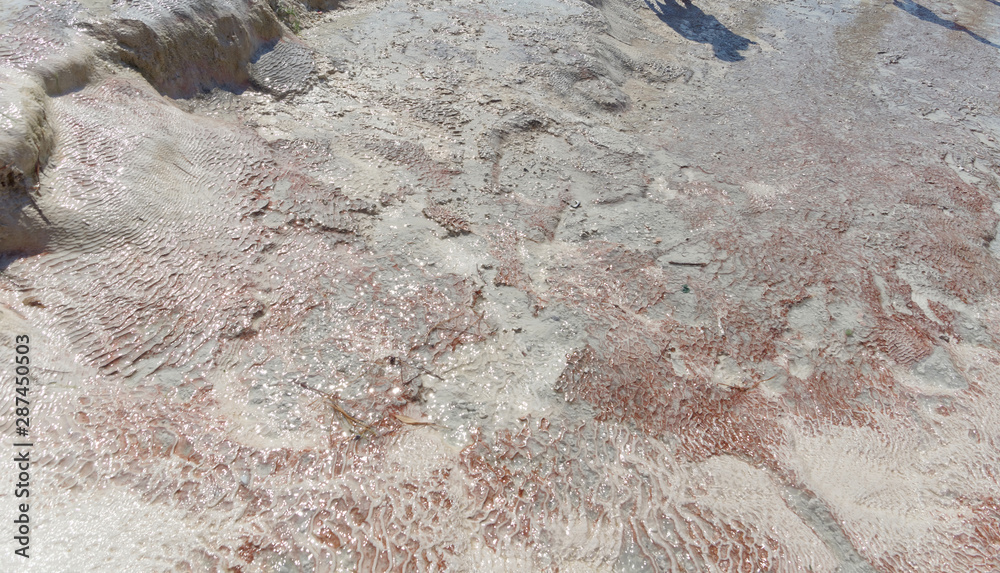 Snow-white salt deposits on the stone slopes created natural patterns.