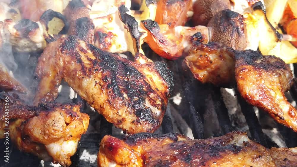 Delicious looking meat cooking on a burning grill.Food cooking on a steaming barbeque.
