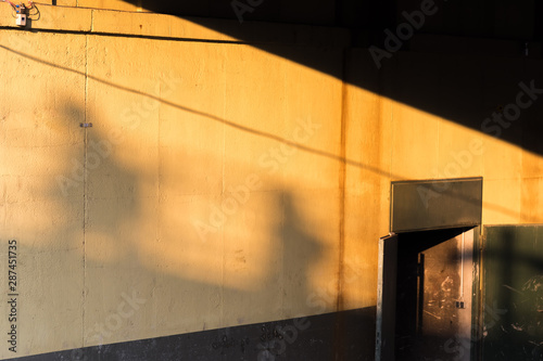 Two pedestrians go from the dark to the light photo