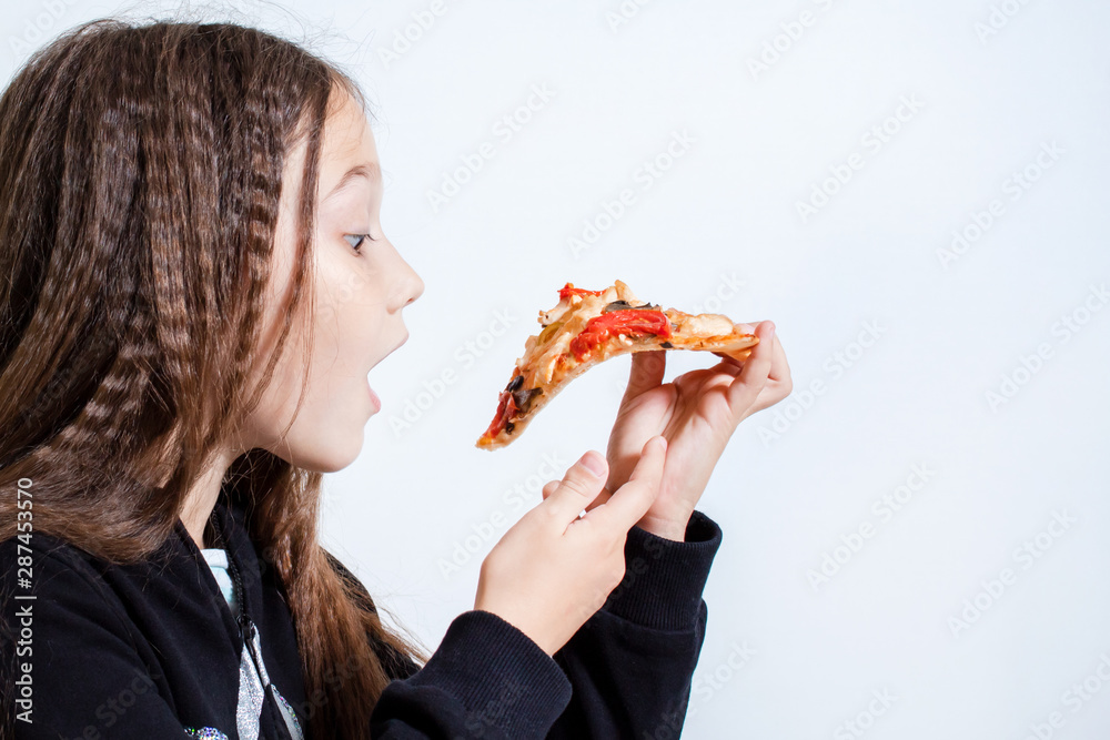 Little girl eating pizza. Baby puts pizza in her mouth Little girl eating pizza. Baby puts pizza in her mouth