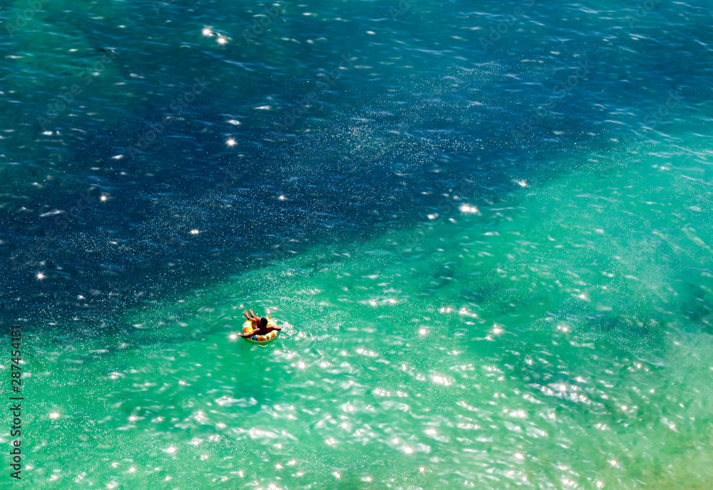 man relaxing on a float on the atlactic ocean coast